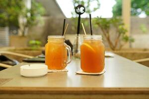 lemon tea, 2 cold drinks in glass cup side view with cloth base photo