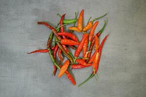 bunch of fresh chilies on a concrete background photo