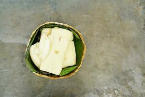 fermented cassava in a basket on a concrete background photo