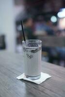 Chocolate milkshake with chocolate pieces and cake on top, cafe background atmosphere photo