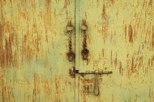 building exteriors. yellow metal door with classic door handle photo