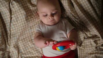 Infant baby playing with rattle toy. video