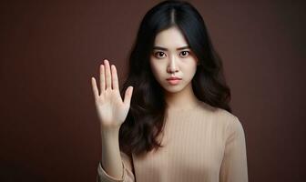 Asian woman with a firm stop hand signal. AI generative. photo