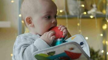 Baby bitting a teether toy. Baby teething concept. video