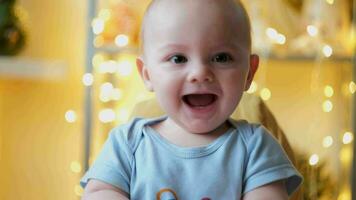 Cute little baby laughing, golden lights on background. video