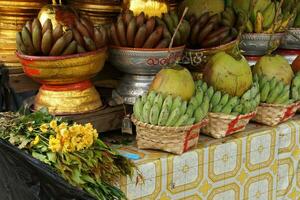 Baskets of green bananas and coconuts photo
