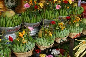 Baskets of green bananas and coconuts photo