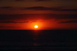 picturesque ocean landscape with the setting sun in a tropical country during summer holidays photo