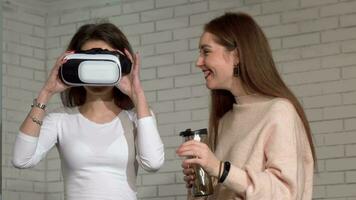 Two lovely female friends using 3d virtual reality goggles together video