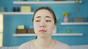 Close-up of sad and sad Asian young woman. video