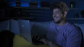 Cheerful and happy young man at home at night. video