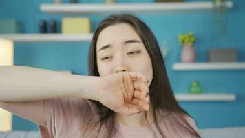 Close-up portrait of tired and sleepy Asian young woman. video