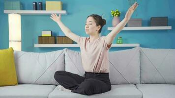 Happy and peaceful Asian teenage girl does breathing exercise. video