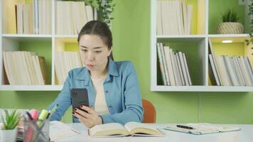 Studying Asian teenage girl talking facetime online. video