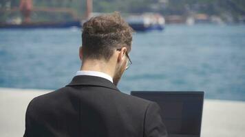 Businessman in suit working on laptop. video