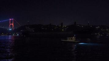 Dark giant ship passing through the Bosphorus at night. video