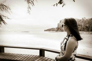Vintage style woman looking at the sea in Thailand photo