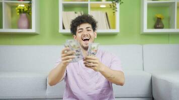 The man with a lot of money throws paper money and is happy. video