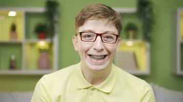 Young man with braces looking at camera close-up video