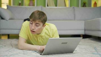 Young man doing secret work on laptop at home. video