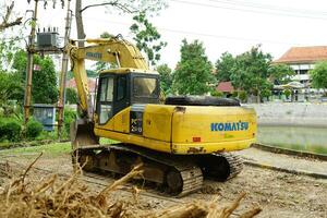 heavy equipment excavators are clearing land for industrial needs photo