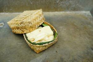 fermented cassava in a basket on a concrete background photo