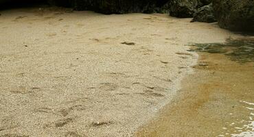 Close-up shot. beach sand and coral mountains in the background. photo