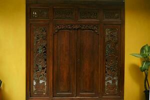 Traditional carved wooden door with beautiful and extraordinary details photo