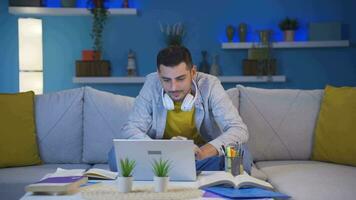 Successful student looks at the camera with a smile while studying at home. video