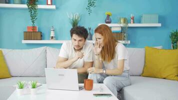 Married couple watching horror movie on laptop at home. video