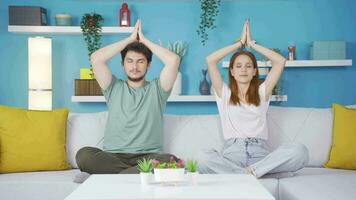 Married couple meditating at home. video