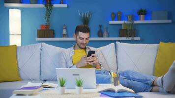 Man lying on sofa is using phone. Pleasant and comfortable posture. video