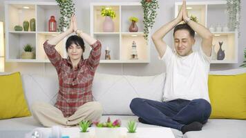 Married couple meditating at home. video