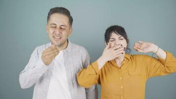 Couple yawning at camera. They are sleepless. video