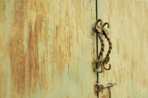 building exteriors. yellow metal door with classic door handle photo