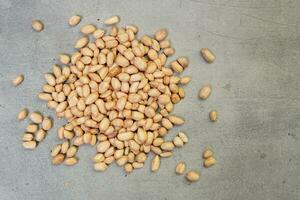 fresh peanuts on concrete background photo