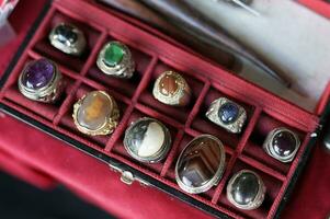 traditional jewelry, natural stones are made into rings on display photo