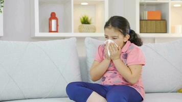 Girl child covering his mouth and nose with a tissue while sneezing. video