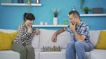 Married couple playing chess at home. video