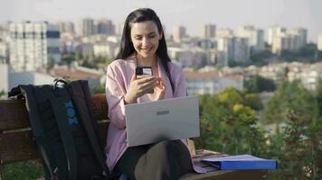 Phone addict Businesswoman using phone outdoors. video