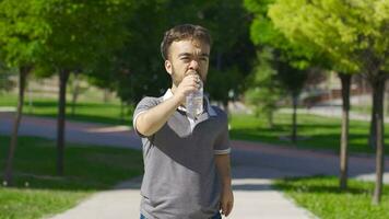 Dwarf young man drinking water. Water for healthy life. video