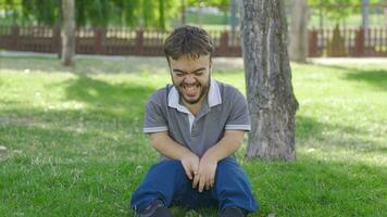 The dwarf young man laughing to himself in the park is insane. video