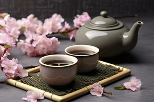 Traditional ceremony. Cups of brewed tea, teapot and sakura flowers on grey table. Generative AI photo