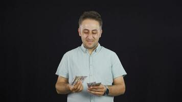 Man counting money looking at camera. video