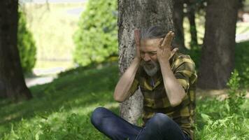 Man having a nervous breakdown slaps himself outside. video