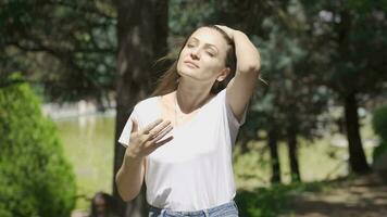 The woman is suffocating from the sunny and hot weather outside. video