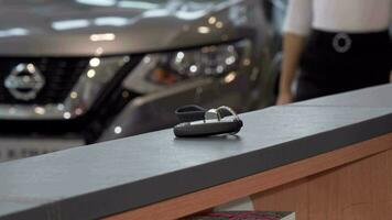 Unrecognizable woman taking car keys from the table at dealership salon video