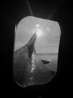 Beautiful view from airplane window, large wing of aircraft shows casement photo