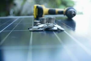 Stack of coins on solar panel The idea of installing solar cells gives you more money and more left over for savings. photo