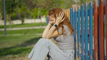 Young woman having nervous breakdown slaps herself outdoors. video